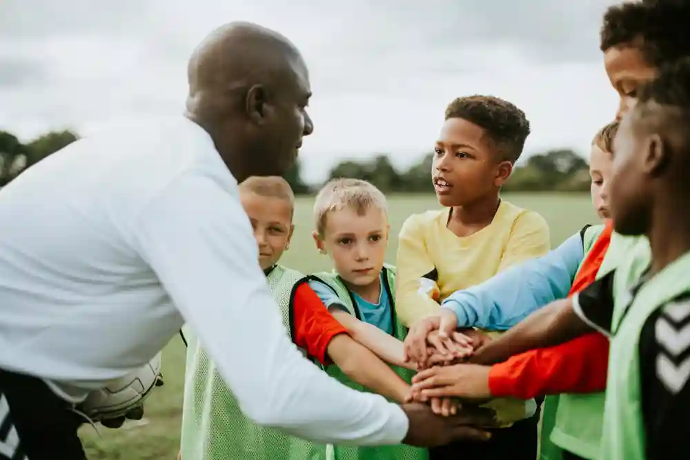 Coach kinderen buiten grasveld sport